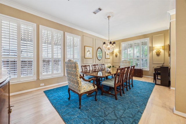 7904 Briar Brook Ct, Dallas, TX 75218 - dining space with wood finished floors, a chandelier, ornamental molding, and baseboards