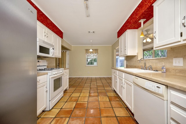 320 Gloria St, Keller, TX 76248 - kitchen featuring white appliances, a sink, plenty of natural light, and white cabinetry