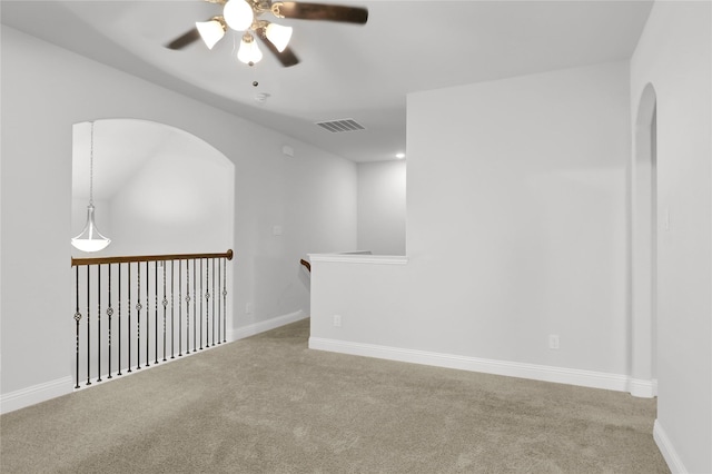 2917 Bobcat Dr, Melissa, TX 75454 - spare room with carpet flooring, a ceiling fan, arched walkways, and baseboards