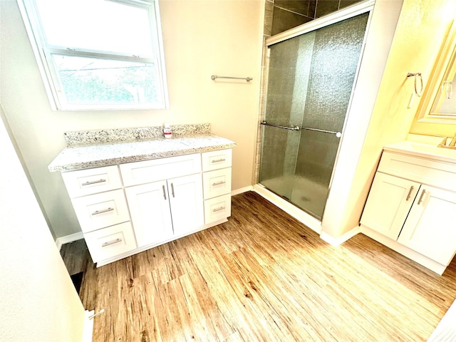 177 Catfish Trl, Whitney, TX 76692 - bathroom featuring wood finished floors, a shower stall, vanity, and baseboards