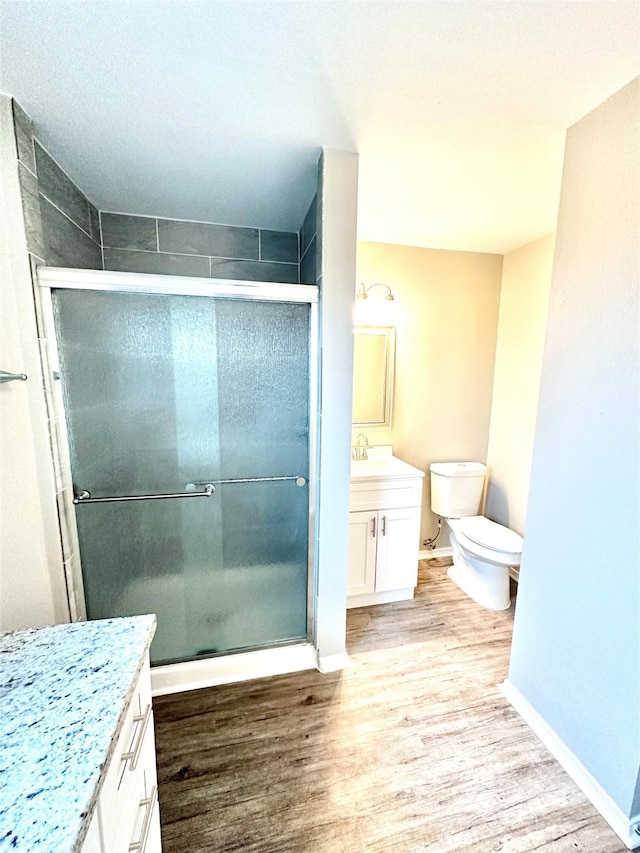 177 Catfish Trl, Whitney, TX 76692 - bathroom featuring vanity, wood finished floors, a stall shower, and toilet