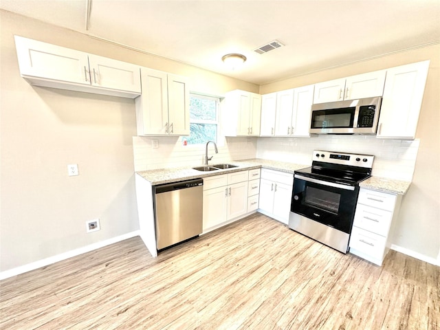 177 Catfish Trl, Whitney, TX 76692 - kitchen featuring stainless steel appliances, a sink, light wood-style flooring, and baseboards