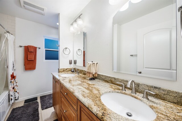 bathroom featuring double vanity, baseboards, and shower / bathtub combination with curtain