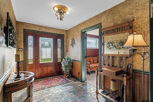 1847 N State Highway 19, Emory, TX 75440 - foyer entrance with brick flooring, wallpapered walls, and a wainscoted wall