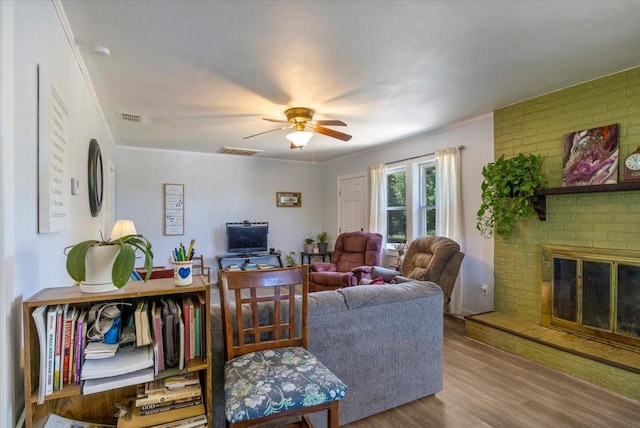 13591 County Road 420, Tyler, TX 75704 - living area with wood finished floors, a ceiling fan, a fireplace, and ornamental molding