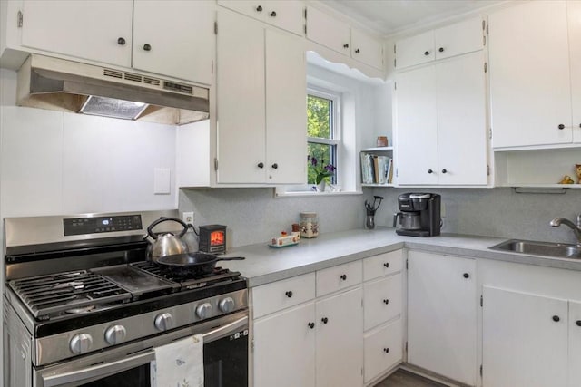 13591 County Road 420, Tyler, TX 75704 - kitchen with stainless steel gas stove, under cabinet range hood, a sink, open shelves, and light countertops