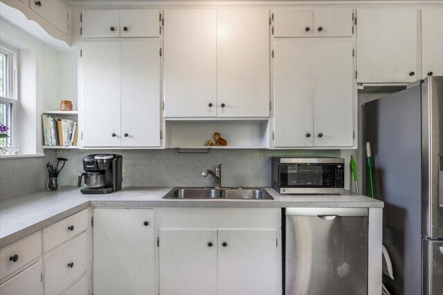 13591 County Road 420, Tyler, TX 75704 - kitchen with open shelves, appliances with stainless steel finishes, a sink, and light countertops