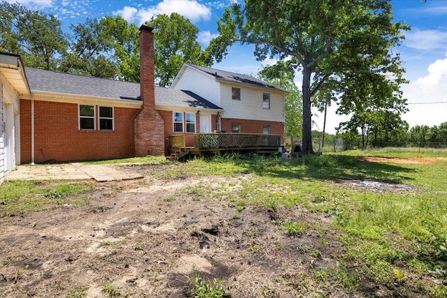 13591 County Road 420, Tyler, TX 75704 - rear view of house featuring brick siding, a chimney, and a wooden deck
