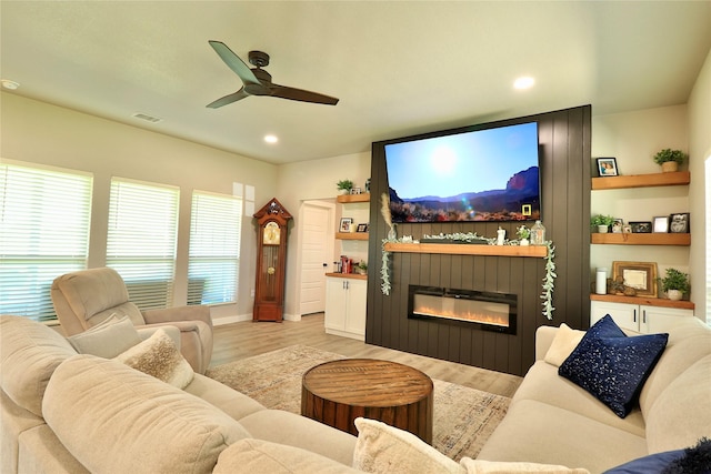 130 County Road 2630, Decatur, TX 76234 - living room with a glass covered fireplace, light wood-style floors, ceiling fan, recessed lighting, and baseboards