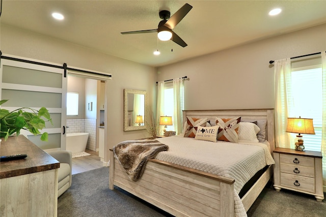 130 County Road 2630, Decatur, TX 76234 - bedroom featuring a barn door, ensuite bathroom, recessed lighting, ceiling fan, and dark carpet