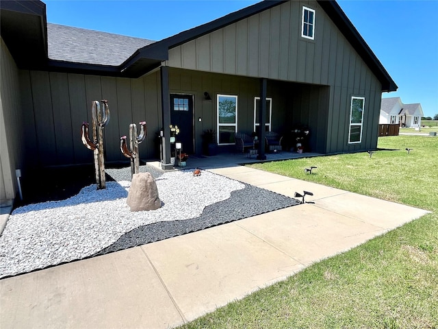 130 County Road 2630, Decatur, TX 76234 - rear view of house with a yard, a patio area, roof with shingles, and board and batten siding