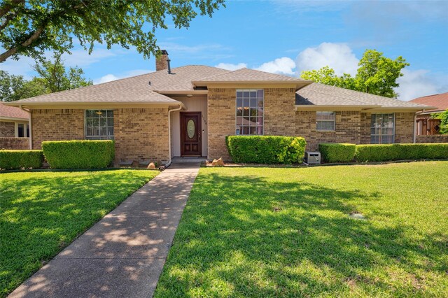 1706 Morningstar Trl, Richardson, TX 75081 - ranch-style home with a chimney, a front yard, brick siding, and a shingled roof