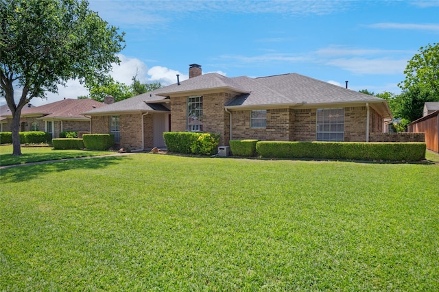 1706 Morningstar Trl, Richardson, TX 75081 - view of front of home featuring a chimney, a front yard, and brick siding