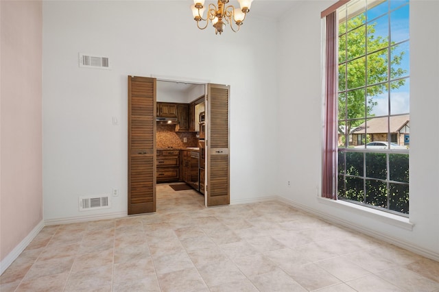 1706 Morningstar Trl, Richardson, TX 75081 - unfurnished room featuring a chandelier, light tile patterned flooring, and baseboards