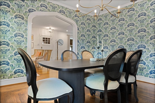 1143 N Winnetka Ave, Dallas, TX 75208 - dining space featuring wallpapered walls, a chandelier, arched walkways, baseboards, and ornamental molding