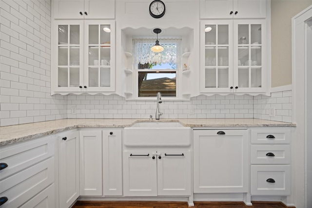 1143 N Winnetka Ave, Dallas, TX 75208 - kitchen featuring a sink, white cabinetry, and tasteful backsplash
