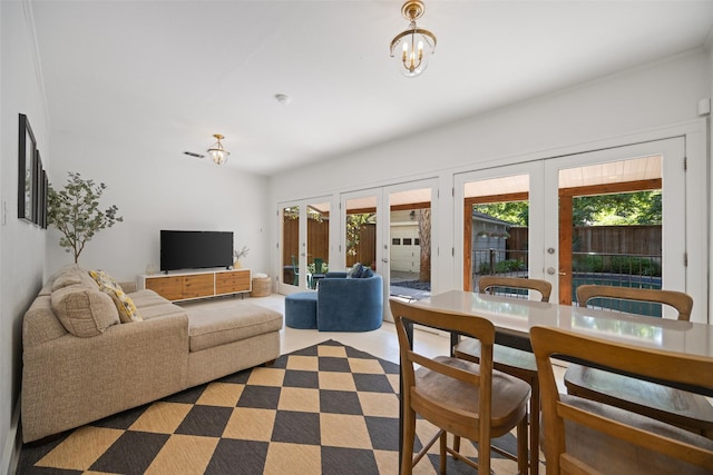 1143 N Winnetka Ave, Dallas, TX 75208 - living room with french doors, healthy amount of natural light, and a chandelier
