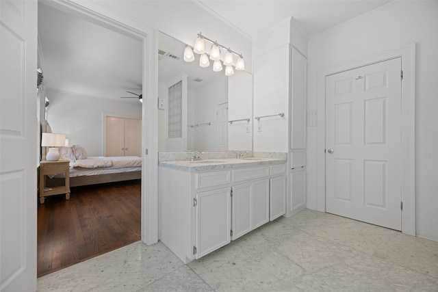 1143 N Winnetka Ave, Dallas, TX 75208 - ensuite bathroom featuring ceiling fan, double vanity, and ornamental molding