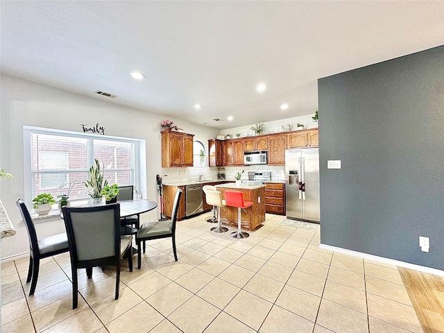 6468 Payton Dr, Fort Worth, TX 76131 - kitchen with stainless steel appliances, a kitchen island, light countertops, tasteful backsplash, and recessed lighting