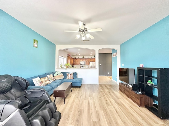 6468 Payton Dr, Fort Worth, TX 76131 - living area featuring arched walkways, a ceiling fan, and light wood-type flooring