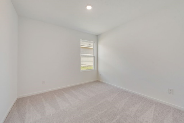 empty room with light carpet and baseboards