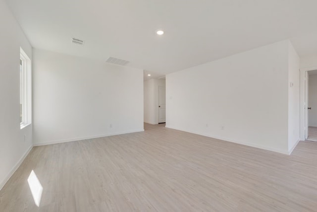 spare room with light wood-style flooring, baseboards, and recessed lighting