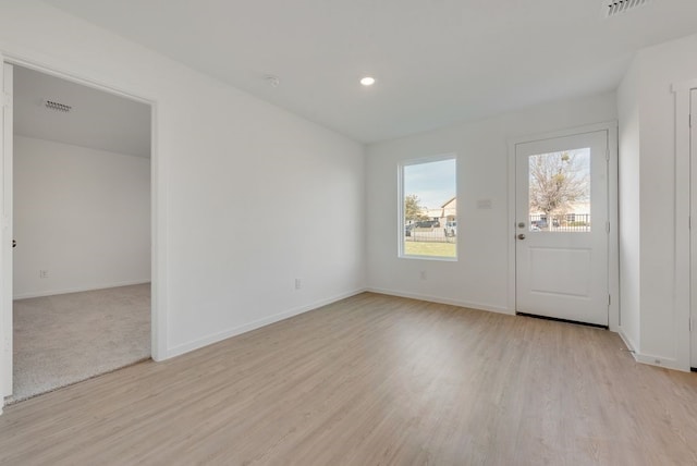 unfurnished room with light wood-style flooring, baseboards, and recessed lighting