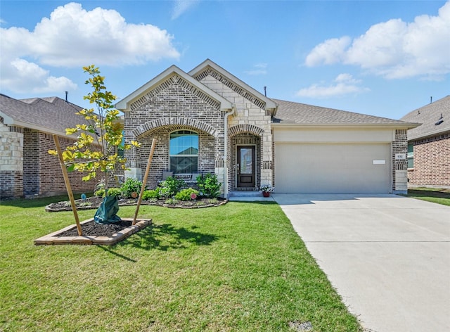 832 Garner Dr, Fate, TX 75087 - french country home featuring a garage, driveway, brick siding, and a front yard