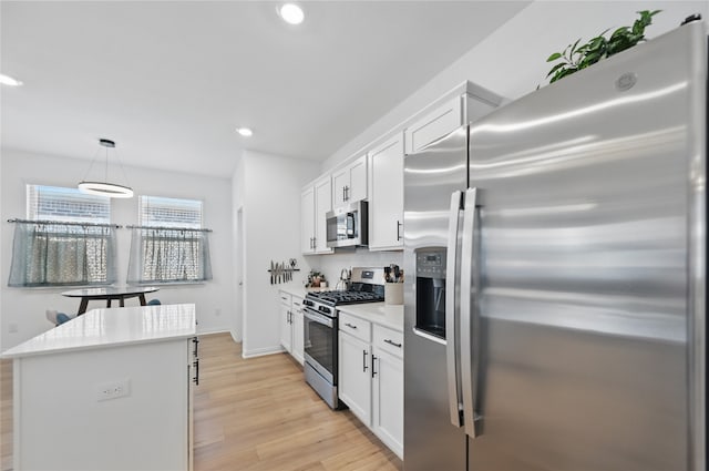 832 Garner Dr, Fate, TX 75087 - kitchen with appliances with stainless steel finishes, recessed lighting, light wood-style flooring, white cabinetry, and light countertops