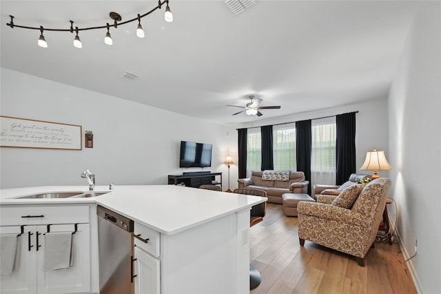 832 Garner Dr, Fate, TX 75087 - kitchen featuring a sink, stainless steel dishwasher, light wood finished floors, and white cabinets