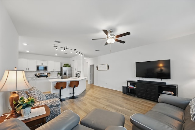 832 Garner Dr, Fate, TX 75087 - living room featuring ceiling fan, light wood-style flooring, baseboards, recessed lighting, and track lighting
