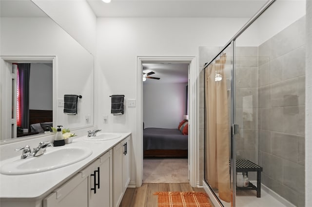 832 Garner Dr, Fate, TX 75087 - ensuite bathroom with a shower stall, wood finished floors, double vanity, and a ceiling fan