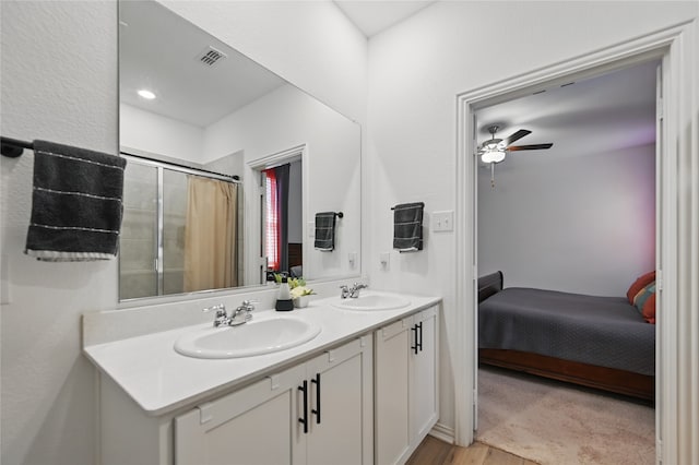 832 Garner Dr, Fate, TX 75087 - ensuite bathroom with ceiling fan, a shower with shower curtain, double vanity, and wood finished floors