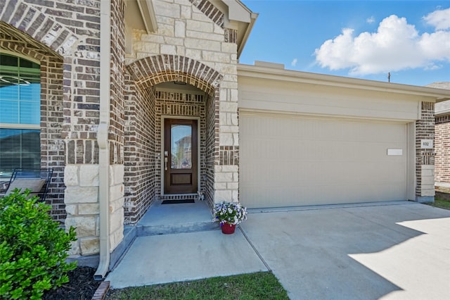 832 Garner Dr, Fate, TX 75087 - doorway to property featuring concrete driveway, an attached garage, brick siding, and stone siding