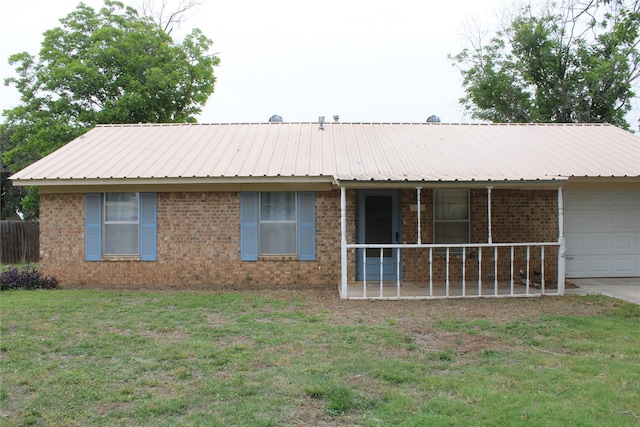 314 Cedar St, Bangs, TX 76823 - view of front facade featuring an attached garage, brick siding, a front yard, and metal roof