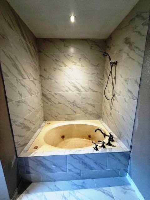 426 Gun Club Rd, Denison, TX 75021 - bathroom with marble finish floors, a bath, and a tile shower