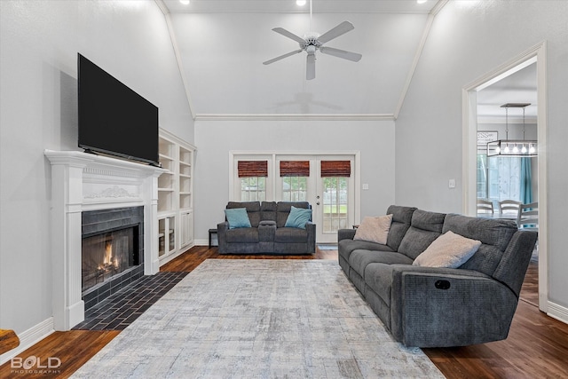 4013 Wisteria Ln, Benton, LA 71006 - living room featuring a ceiling fan, a fireplace with flush hearth, dark wood-style flooring, a chandelier, and high vaulted ceiling