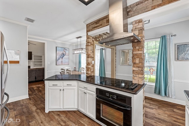 4013 Wisteria Ln, Benton, LA 71006 - kitchen featuring black appliances, dark countertops, wall chimney range hood, dark wood finished floors, and ornamental molding