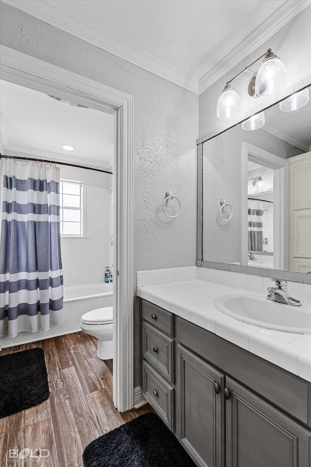 4013 Wisteria Ln, Benton, LA 71006 - bathroom with a textured wall, ornamental molding, wood finished floors, toilet, and vanity