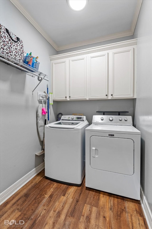 4013 Wisteria Ln, Benton, LA 71006 - laundry area with cabinet space, crown molding, washer and clothes dryer, wood finished floors, and baseboards