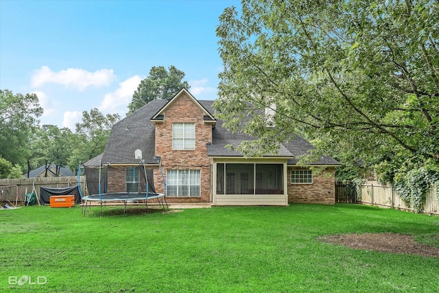 4013 Wisteria Ln, Benton, LA 71006 - rear view of house featuring brick siding, a trampoline, a shingled roof, and a sunroom
