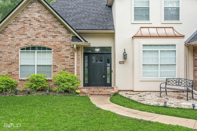 4013 Wisteria Ln, Benton, LA 71006 - property entrance featuring roof with shingles, a yard, brick siding, and stucco siding