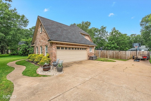 4013 Wisteria Ln, Benton, LA 71006 - view of home's exterior featuring brick siding, a shingled roof, and concrete driveway