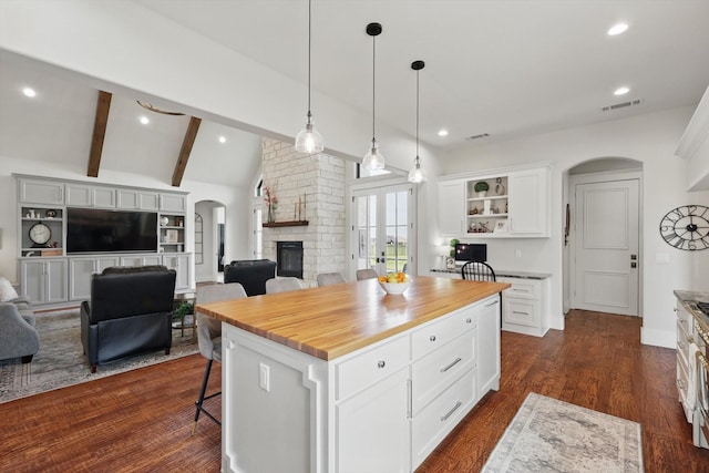 1316 Sparrow Hawk Ln, Gunter, TX 75058 - kitchen featuring arched walkways, open floor plan, wood counters, a breakfast bar area, and recessed lighting