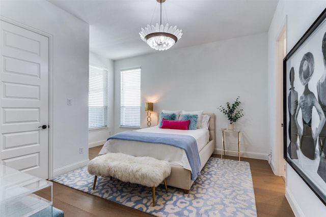 2228 Sandrellan St, Fort Worth, TX 76008 - bedroom featuring a chandelier, wood finished floors, and baseboards