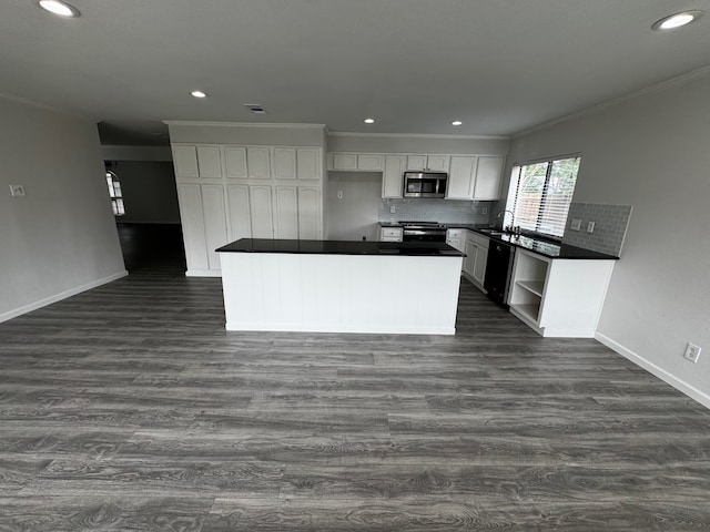 2910 Raintree Dr, Plano, TX 75074 - kitchen with stainless steel appliances, dark countertops, white cabinetry, dark wood-type flooring, and ornamental molding