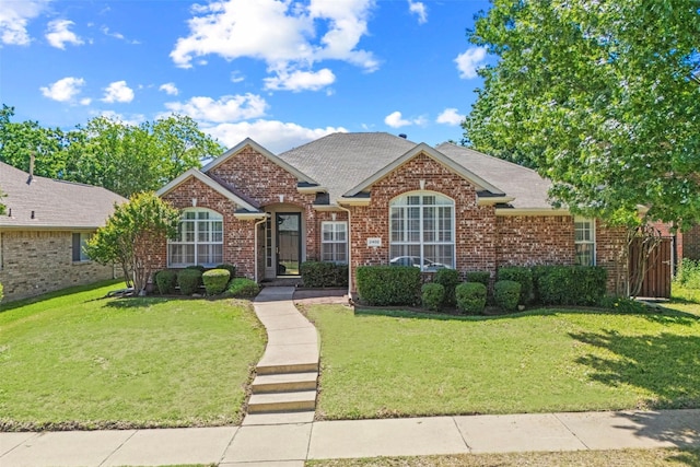 2402 Greenfield Cir, Garland, TX 75040 - traditional-style house featuring a front yard, brick siding, and a shingled roof