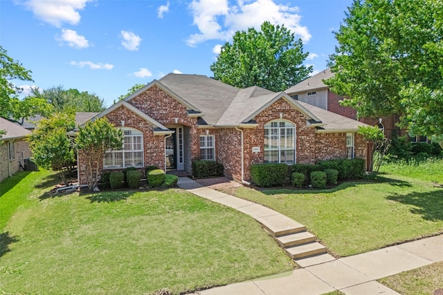2402 Greenfield Cir, Garland, TX 75040 - traditional-style house with brick siding, a front lawn, and roof with shingles