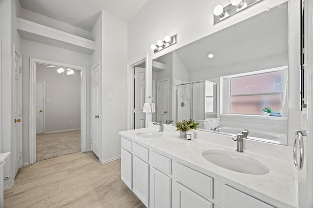 2402 Greenfield Cir, Garland, TX 75040 - bathroom with a shower stall, a garden tub, double vanity, and baseboards