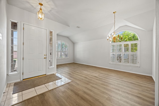 2402 Greenfield Cir, Garland, TX 75040 - foyer with vaulted ceiling, a chandelier, wood finished floors, and baseboards